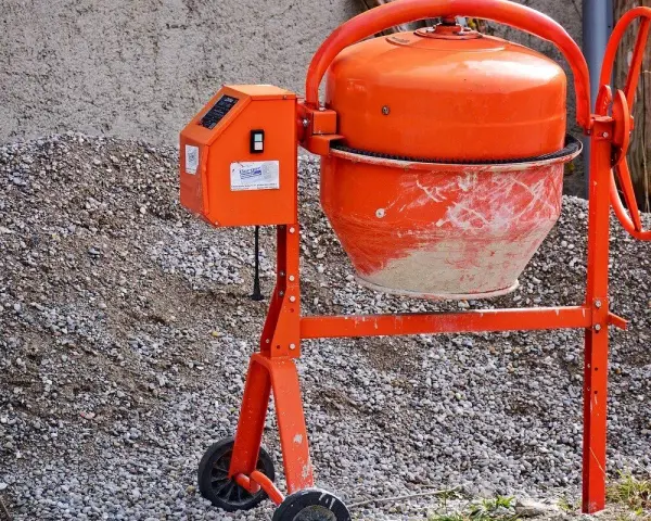 Pomarańczowa betoniarka gotowa do pracy. Z jej pomocą szybko przygotujesz beton B25 na budowę.
