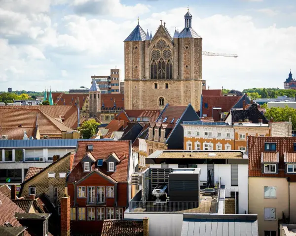 Blick über Dächer auf eine Kirche. Über den Austritt aus der Kirche und steuerliche Folgen wird nachgedacht.