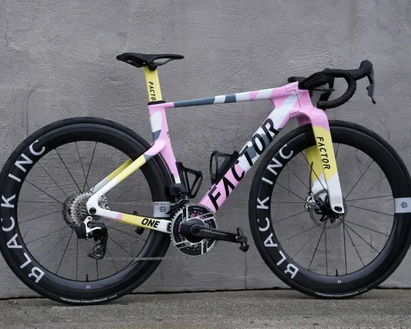 A stylish pink, yellow, and grey Factor road bike, perfect for women beginners looking for a fun and fast ride.