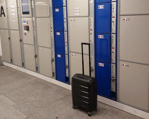 Przechowalnia bagażu Warszawa Centralna. Czarna walizka czeka przed rzędem szafek.