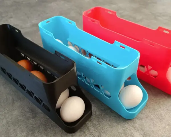3D printed egg holders in black, blue, and red. See what you can do with a 3d printer: create practical kitchen organizers!