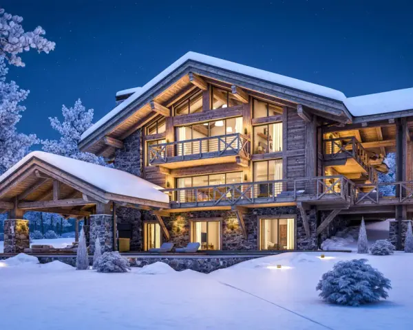 Casa de montaña nevada con luces cálidas, ideal para aerotermia en zonas frías.