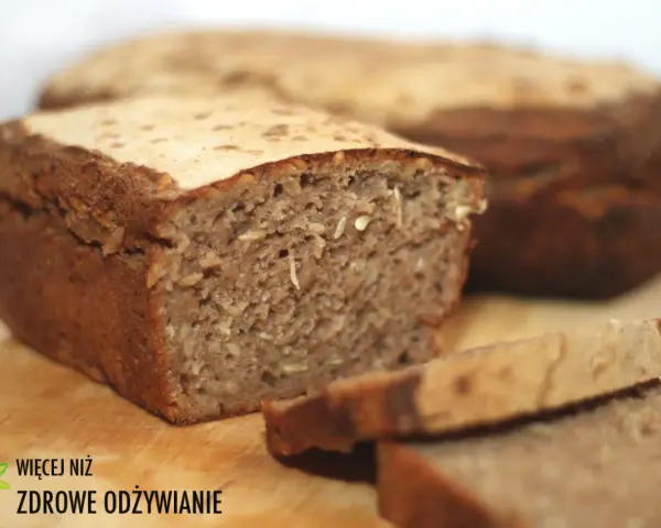 Chleb żytni z ziarnami, pokrojony na kromki, na drewnianej desce.