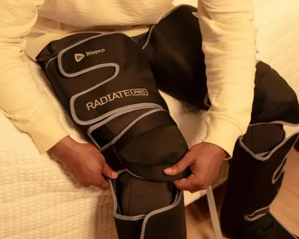Person zips up leg compression machine. Consult your doctor on how long should you use leg compression machine for best results.