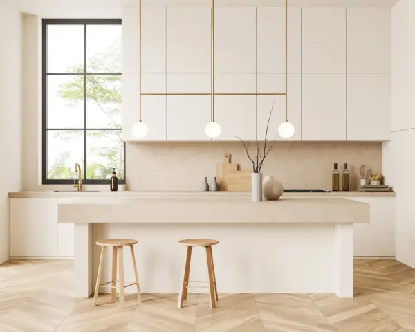 Cocina moderna y luminosa con isla central, taburetes de madera y detalles dorados. Perfecta para decorar cocina con estilo minimalista.