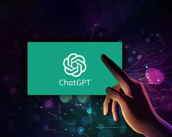 Dłoń dotyka ekranu z logo ChatGPT, symbolizując interakcję z zaawansowaną sztuczną inteligencją GPT.