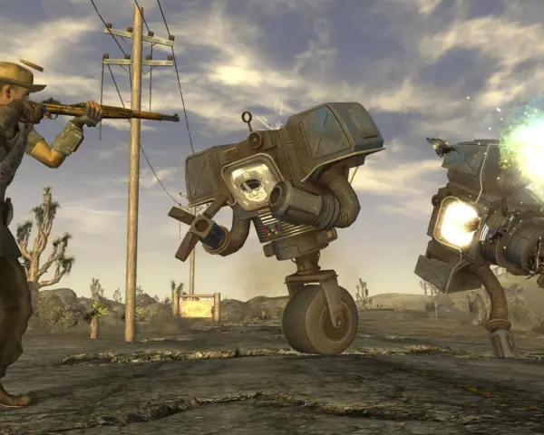 Un personaje con rifle dispara a robots en el desierto. ¡Descubre trucos de Fallout: New Vegas para sobrevivir!