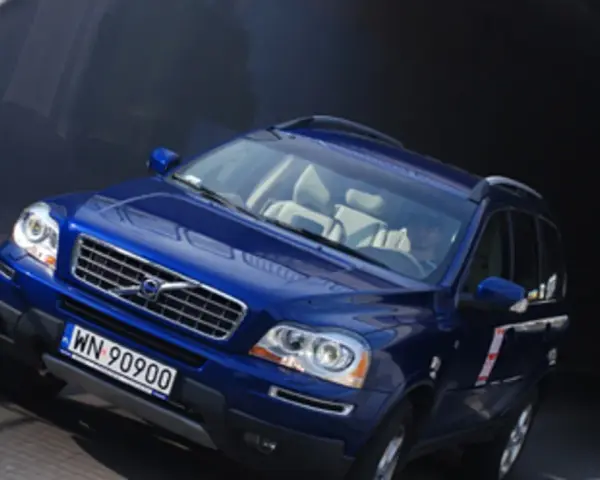 Błękitne Volvo XC90 V8 z jasnym wnętrzem wjeżdża do ciemnego tunelu.