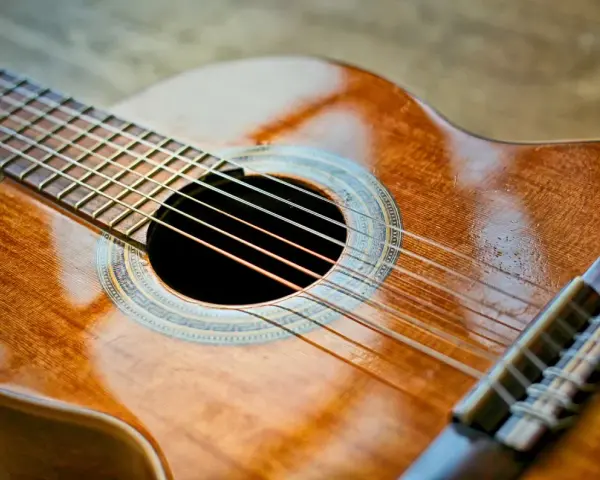 Klasyczna gitara, gotowa do wykonania znanych utworów na gitarę klasyczną. Jej drewniane, lśniące pudło rezonansowe zaprasza do muzycznej podróży.