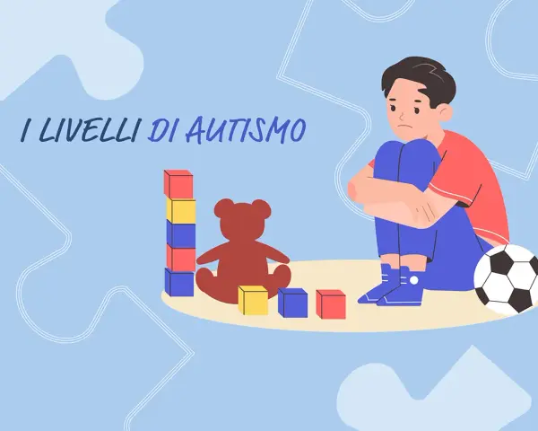 Un bambino con autismo livello 2 gioca con blocchi e un orsacchiotto, mentre un pallone da calcio è vicino.
