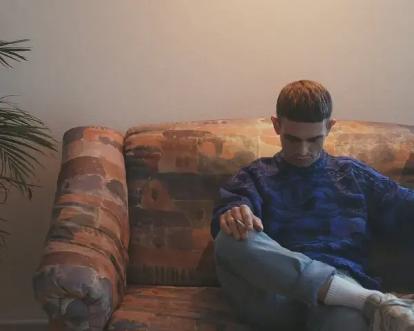 Vito Bambino wpatrzony w dal, siedzi na kanapie. Czyżby myślał o swojej nowej płycie?
