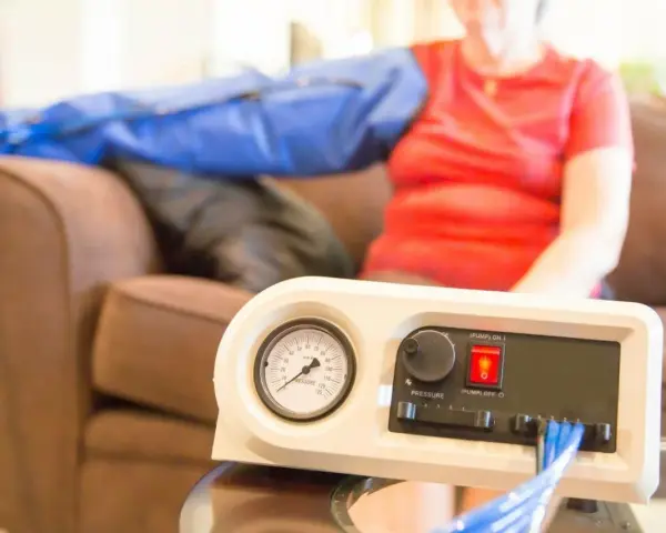 A person uses a lymphedema pump on their arm. Consult your doctor about how often you can use your lymphedema pump.