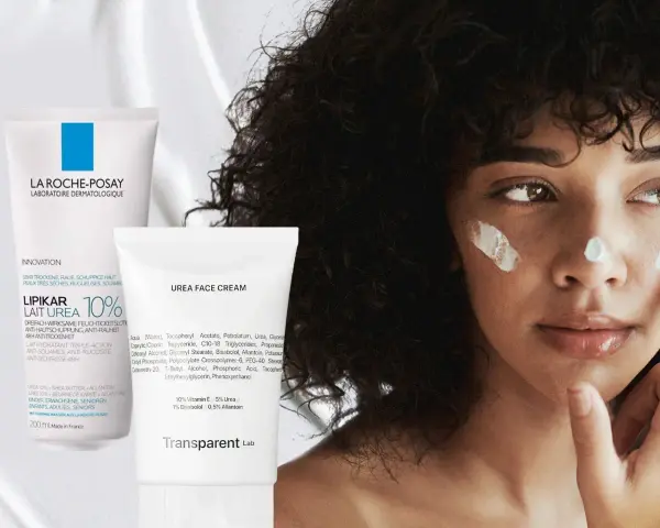Eine Frau mit lockigem Haar trägt Gesichtscreme auf. Links sind zwei Tuben zu sehen, eine mit "Urea 10%" und eine mit "Urea Face Cream".