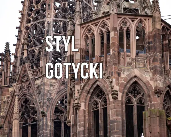 Kamienna wieża katedry w stylu **gotyckim**, z misternymi detalami i łukami.