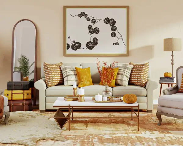Acogedor salón con sofá, sillones y mesa de centro. Destaca una **gama colores cálidos** en cojines, mantas y decoración otoñal.