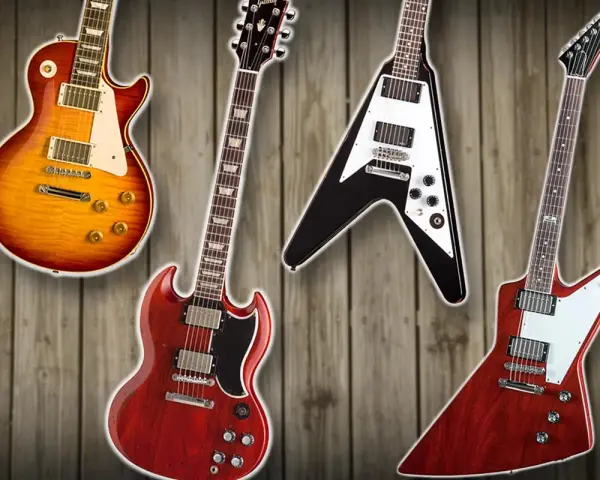 Vier Gibson E-Gitarren: Les Paul, SG, Flying V und Explorer auf Holz Hintergrund.