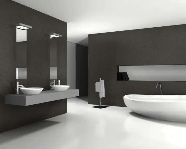 Élégante salle de bain blanc et noir avec baignoire îlot, double vasque et porte-serviettes.