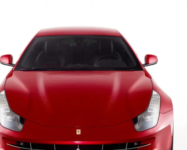 Czerwone Ferrari FF z przodu, z widocznymi reflektorami i grillem.