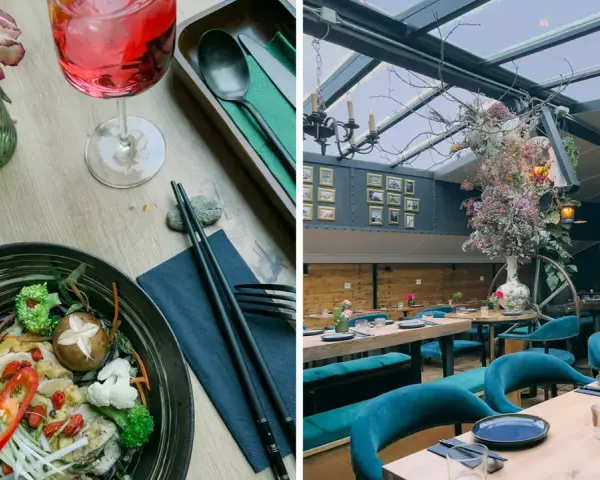 Ein Gericht mit Hühnchen und Gemüse, daneben ein Getränk. Im Hintergrund ein stilvolles Restaurant mit Spree-Blick.