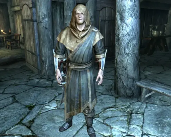 Un personaje con túnica y capucha en Skyrim, listo para curar el vampirismo.