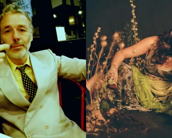 Baxter Dury, aylesbury boy, w żółtym koszuli i garniturze, gestykuluje. Obok Jgrrey w zwiewnej sukni wśród roślin.