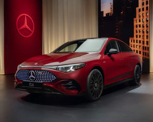Czerwony Mercedes CLA 2025 z podświetlanym grillem i logo gwiazdy. Elegancki design, gotowy na podbój dróg.