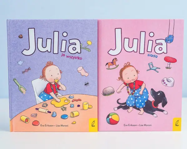 Skandynawskie książki dla dzieci "Julia je wszystko" i "Julia siada" z uroczymi ilustracjami.