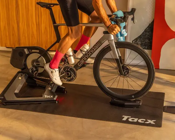 A cyclist trains indoors on a Tacx bike trainer, a device that allows you to ride your bicycle stationary.