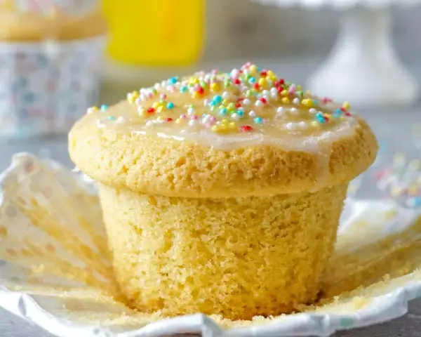 Ein Fanta-Muffin mit Zuckerguss und bunten Streuseln, bereit zum Genießen.