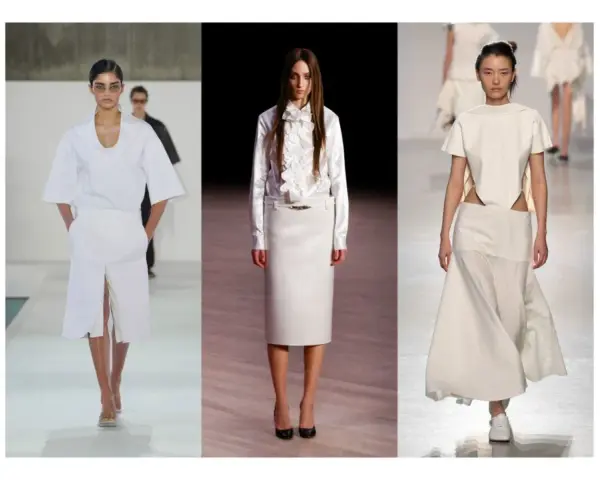 Sfilata di moda con tre modelle che indossano abiti eleganti in **dress code total white**. Gonne lunghe e top asimmetrici.