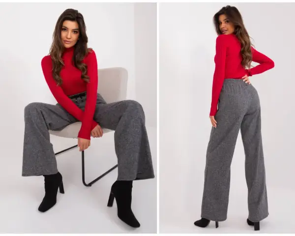 Eleganckie stylizacje z szerokimi spodniami. Modelka w czerwonym golfie i szarych, luźnych spodniach prezentuje modny look.