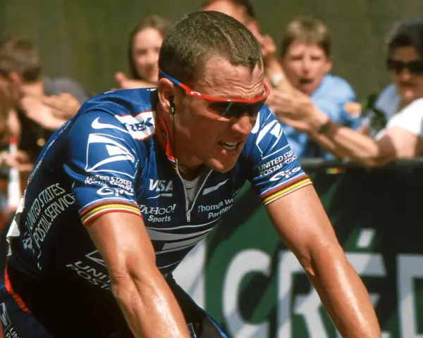 Lance Armstrong, in his USPS jersey, strains during a race, a stark image given how Lance Armstrong cheated his way to victory.