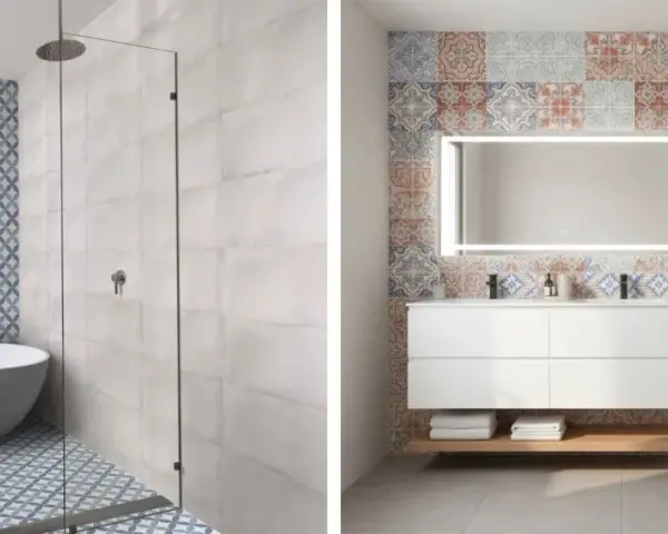 Salle de bain moderne avec baignoire et douche, murs ornés de **carrelage collé** aux motifs géométriques bleus et de carreaux décoratifs colorés.