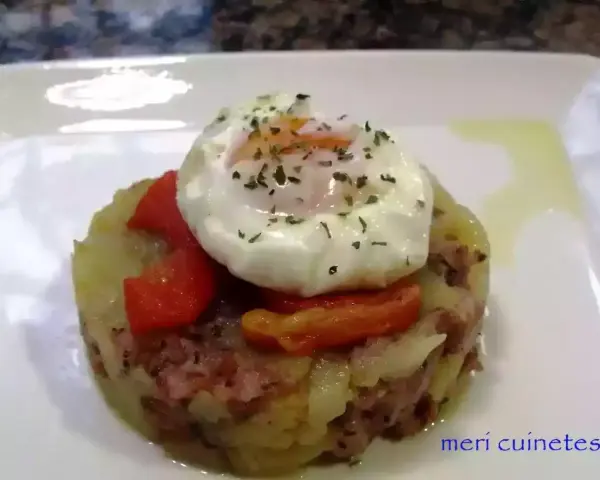 Delicioso timbal de patata con huevo escalfado y pimientos rojos, un plato que te hará chuparte los dedos.