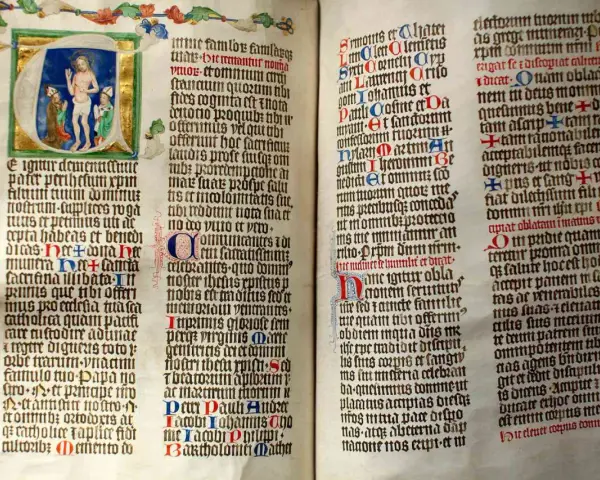 First Sunday of Advent readings from an illuminated manuscript. Jesus is depicted in the initial letter, with ornate borders and calligraphy.