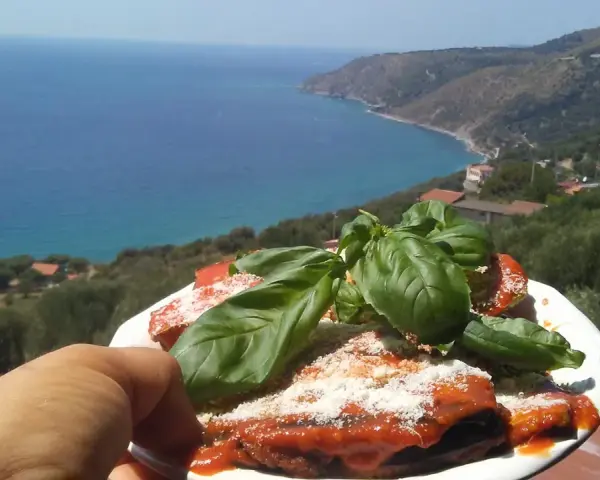 Melanzane alla parmigiana con basilico fresco, con vista sul mare di Marina di Pisciotta.