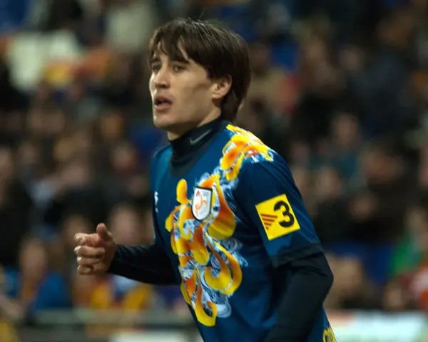 Bojan Krkić w akcji, jego bojan krkić statystyki są imponujące. Piłkarz w niebieskiej koszulce z żółtym wzorem.