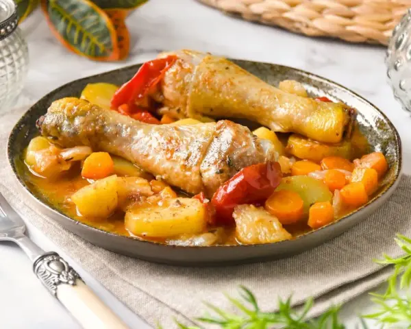 Guiso de pollo con patatas, zanahorias y pimientos en salsa.