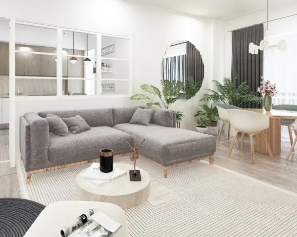 Soggiorno moderno con divano grigio, tavolino rotondo e cucina a vista. L'arredamento minimalista e i toni neutri evocano un caldo **stile nordico**.