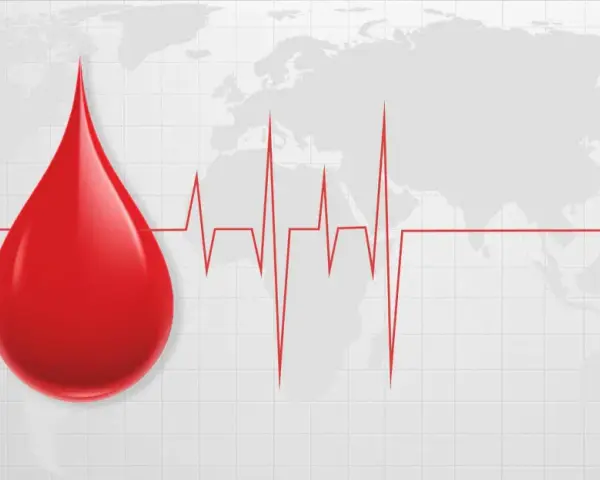 Kropla krwi i EKG na tle mapy świata. Symbolizuje to globalne znaczenie transfuzji i potrzebę pomocy, zwłaszcza gdy w grę wchodzą najrzadsze grupy krwi.