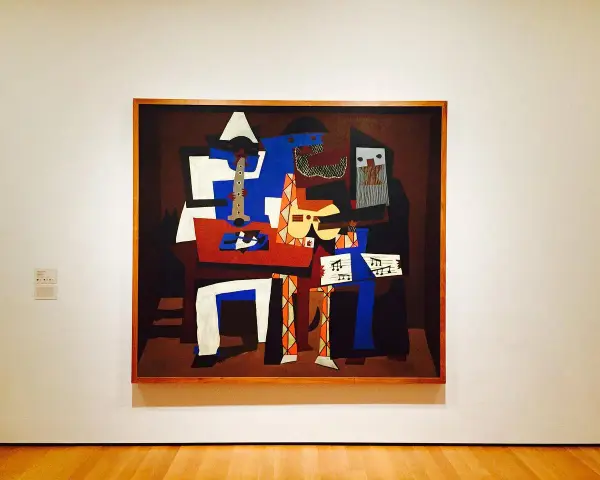 En målning i Picasso stil föreställer musiker med instrument.