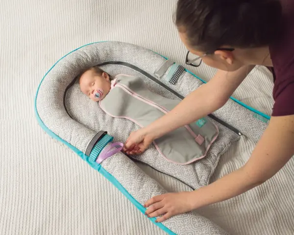 Kokon niemowlęcy zapewnia bezpieczny sen, minimalizując ryzyko śmierci łóżeczkowej. Dziecko śpi spokojnie, otulone w otulacz.