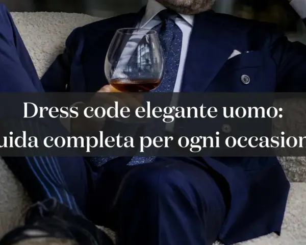 Uomo in abito blu con bicchiere, esplora le diverse dress code tipologie per ogni occasione.