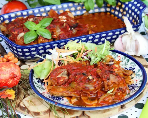 Schab pieczony w sosie pieczarkowym, podany z sałatką. Aromatyczne danie, które zachwyci każdego smakosza.