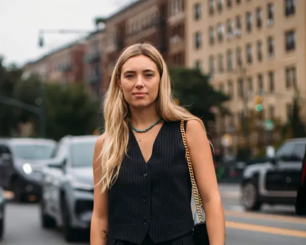 Donna con panciotto gessato, un accessorio che aggiunge un tocco di stile e raffinatezza. Il suo significato è eleganza e audacia.