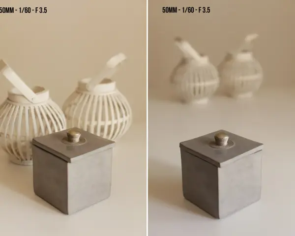 Boîte grise avec couvercle orné d'un bouton argenté, lanternes blanches en arrière plan avec un flou arrière plan artistique.