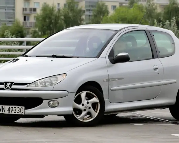 Srebrny Peugeot 206 1.4 benzyna na parkingu.