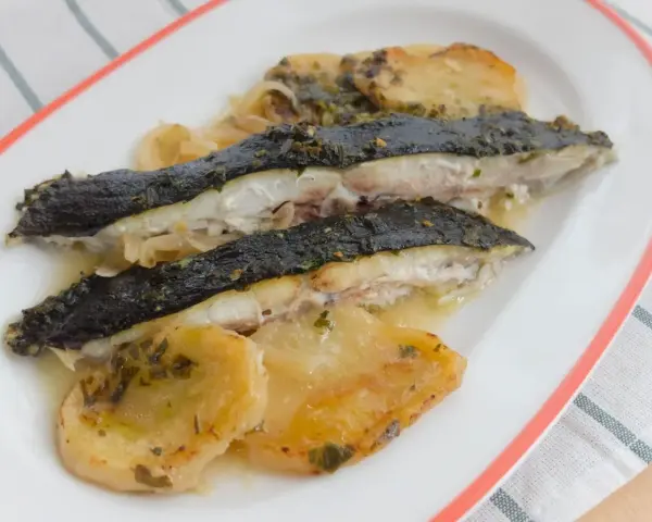Rodaballo al horno con patatas y cebolla, un plato jugoso y lleno de sabor.