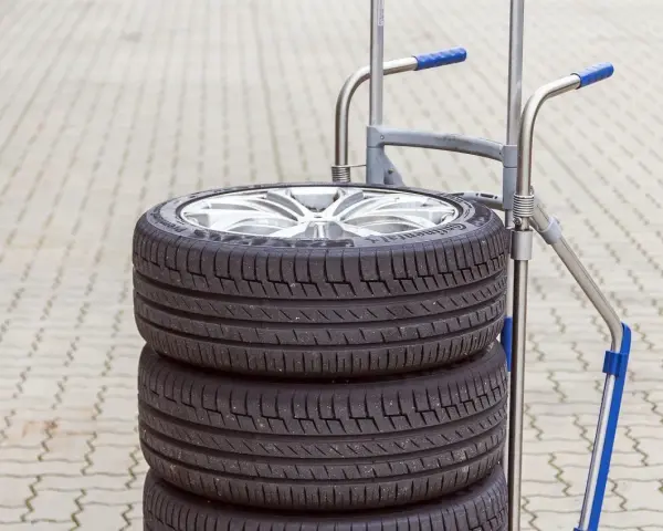 Stos czterech opon samochodowych na wózku. Zastanawiasz się, ile waży opona samochodowa?