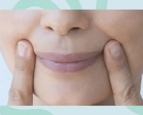 Fingers press into the cheeks, creating dimples. Could this be one of the unexpected side effects of face yoga?